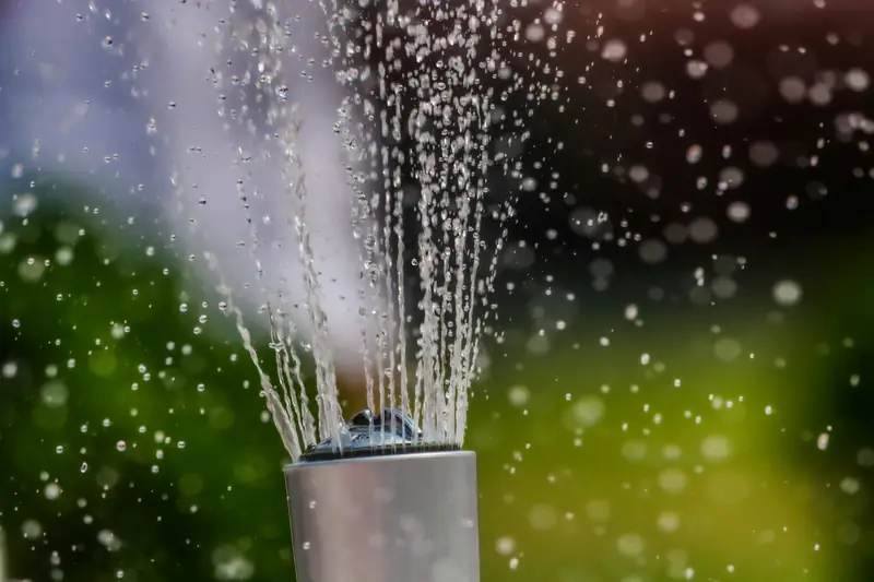 Water shooting straight up out of an open pipe riser
