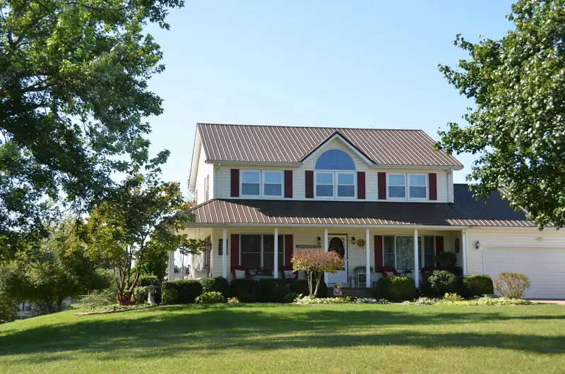 Two-story house with a wide green front lawn